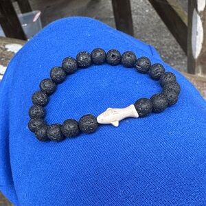 Black Lava Stone Bracelet with Tan Fish Charm